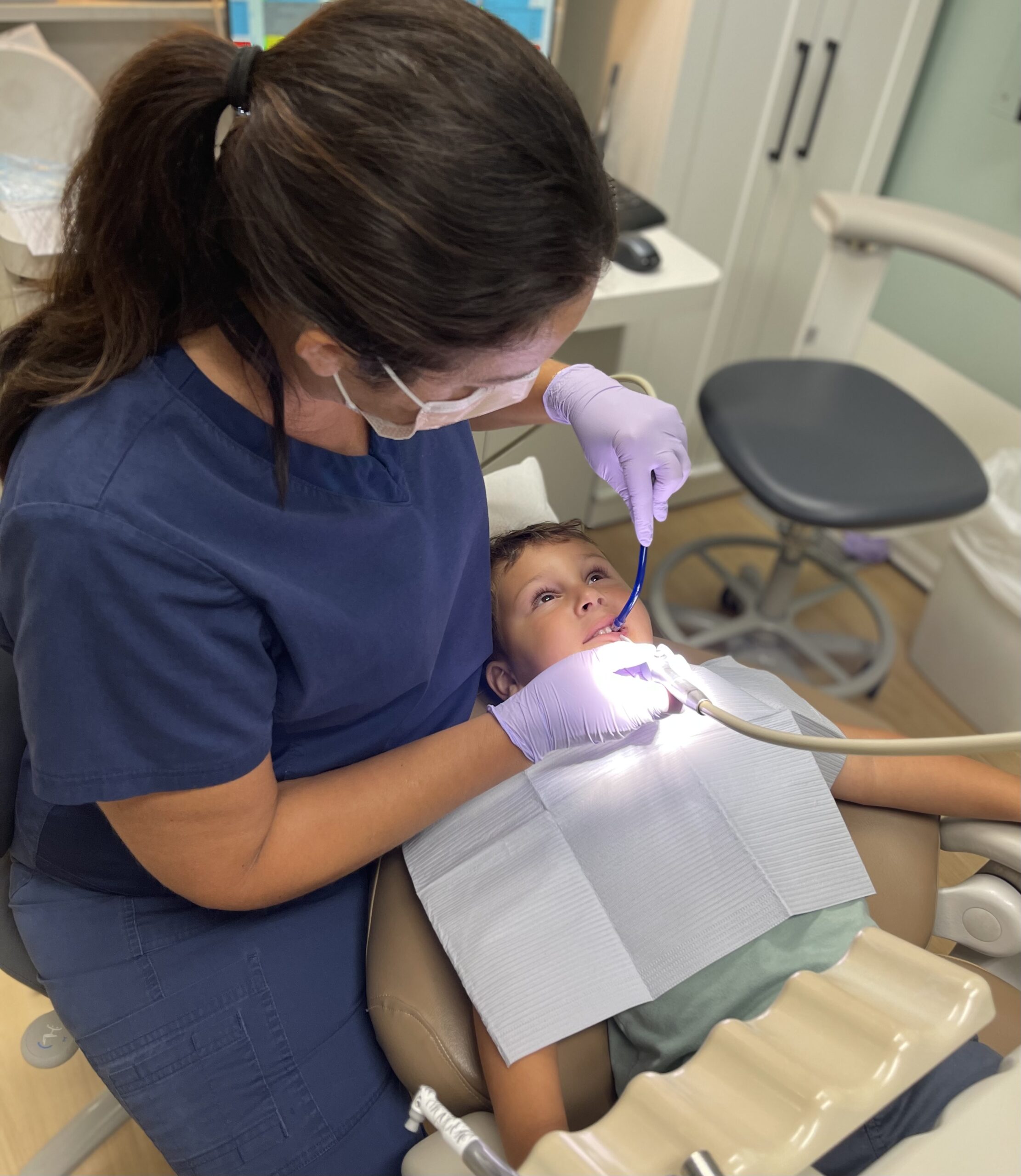 Young boy at a teeth cleaning with a dental hygienist at Deem Dentistry